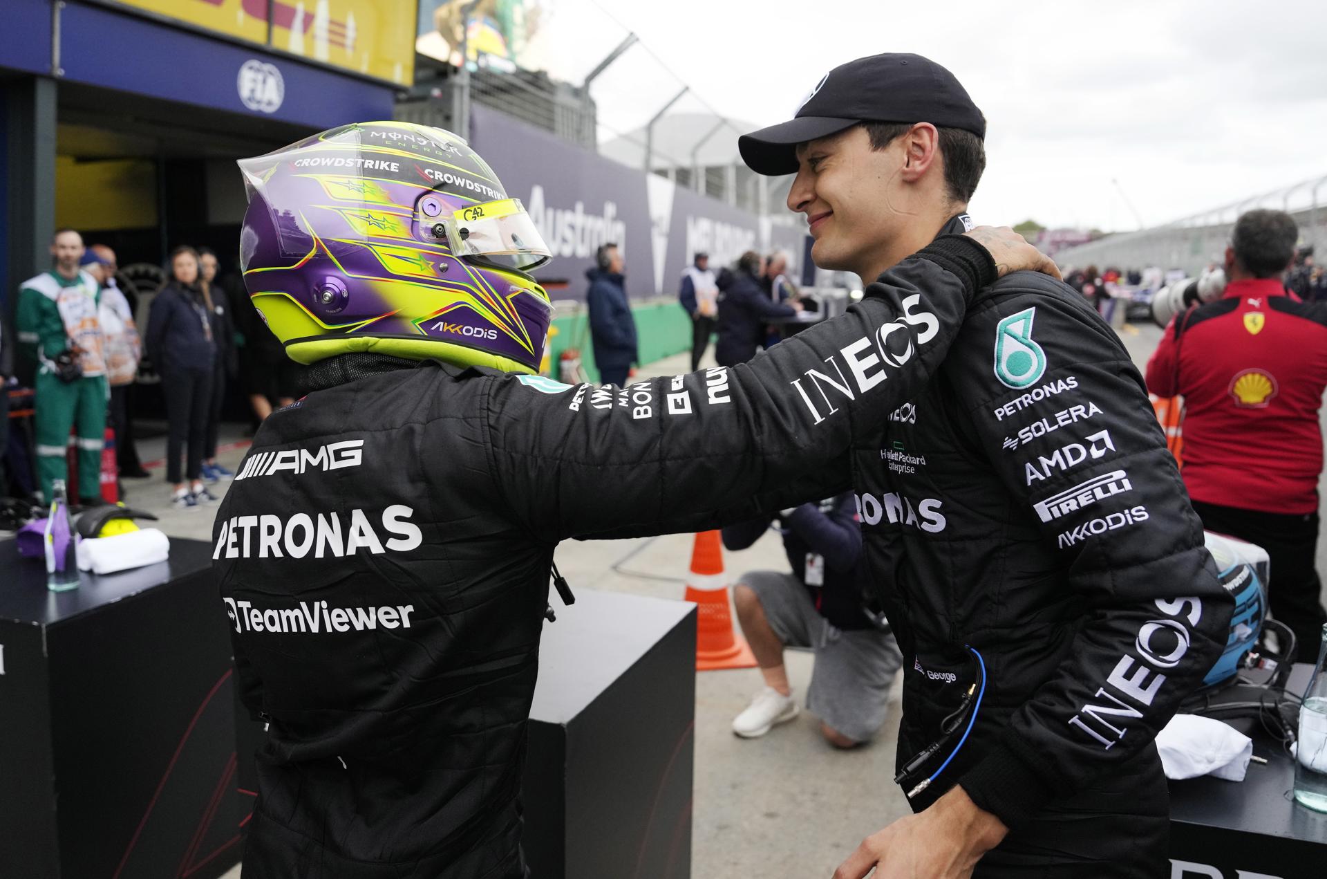 British Formula One driver Lewis Hamilton of Mercedes-AMG Petronas (L) pats teammate George Russell of after the qualifying session at the Formula One Grand Prix of Australia at the Albert Park Circuit in Melbourne, Australia,