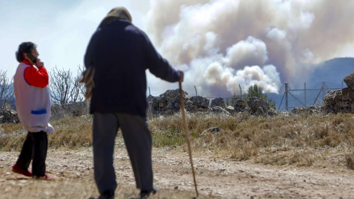 Dos vecinos observan el humo del incendio de Castellón.