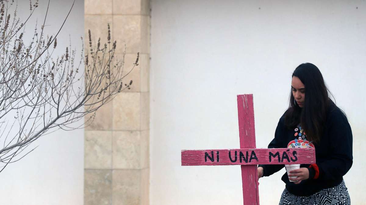 Activistas y madres de víctimas de feminicidios realizan una pinta de cruces y pega de pesquisas en un Memorial en Ciudad Juárez, México.